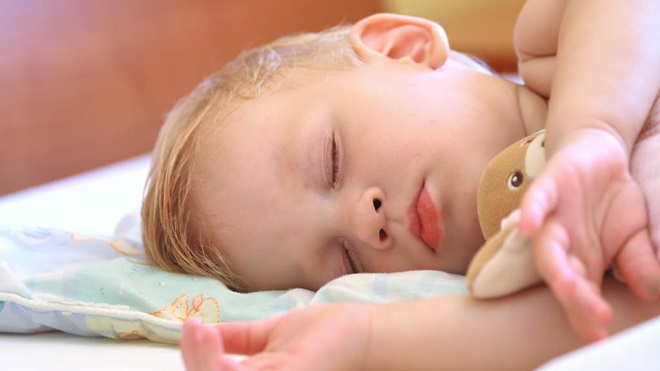 child sleeping with teddy